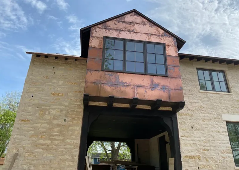 Copper metal panel facade on a stone building for Metal Roof Coating in Galveston