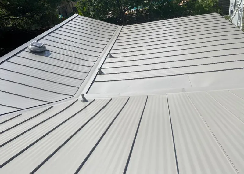 Solar attic fan installed on a metal roof for Roof Ventilation in Galveston